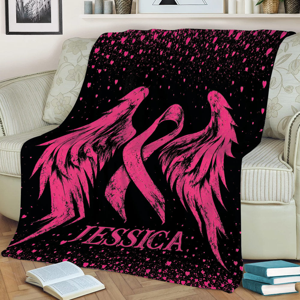 Breast cancer awareness blanket with large pink ribbon wings and heart-speckled black artwork