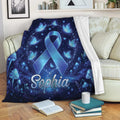Diabetes awareness throw blanket displayed on a sofa with a blue ribbon, butterflies, and celestial blue design