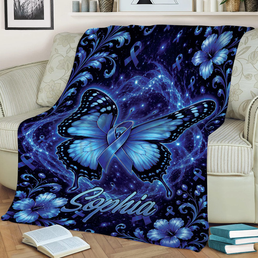 Blue butterfly awareness blanket draped over a couch with floral details and ribbon motifs