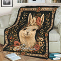 Floral alpaca blanket displayed across a sofa with botanical artwork and decorative border