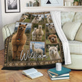 Alpaca throw blanket draped over a sofa, featuring multiple alpaca portraits in rustic framed panels
