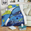 Tennis blanket draped over a sofa with vibrant racket and ball graphics
