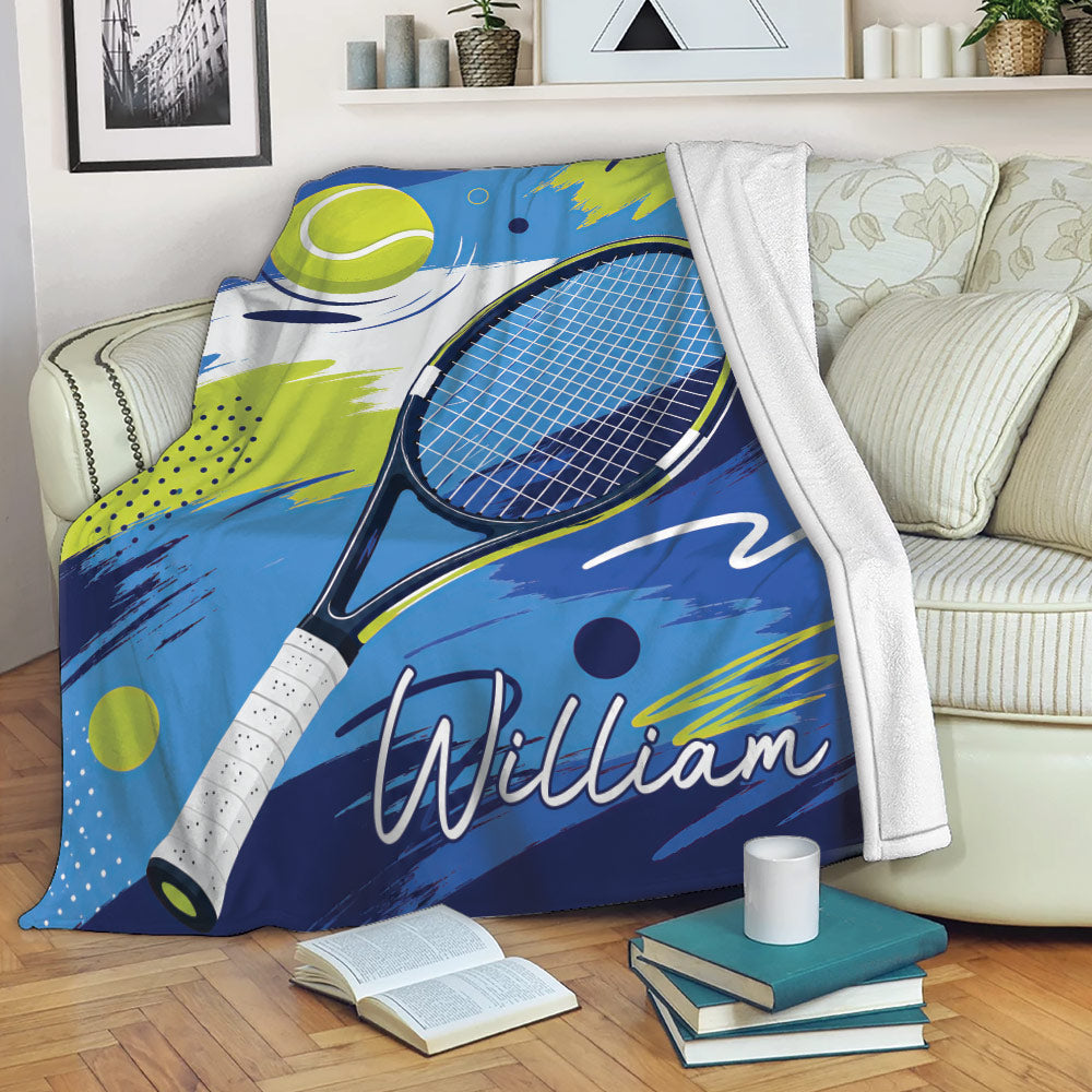 Tennis blanket draped over a sofa with vibrant racket and ball graphics
