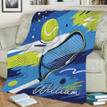 Colorful tennis throw blanket displayed on a couch with racket artwork