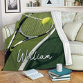 Tennis blanket draped over a sofa with racket and ball artwork in green court colors