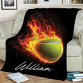 Tennis throw blanket with bold flaming ball artwork styled on a sofa