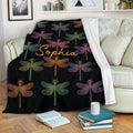 Colorful dragonfly blanket displayed on a sofa in a cozy living room setting