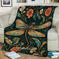 Decorative dragonfly blanket displayed on a couch with vintage-inspired flowers and foliage