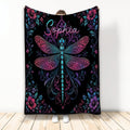 Dragonfly throw blanket with colorful floral border and ornate botanical artwork on a black background