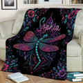 Ornate dragonfly throw blanket displayed on a sofa with colorful botanical and floral details
