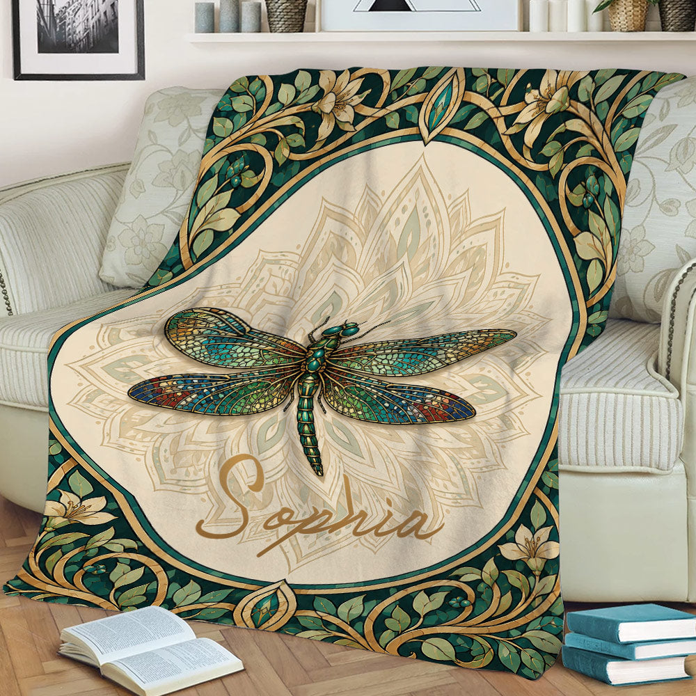 Decorative dragonfly blanket shown on a couch with mandala detailing and leafy floral border