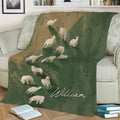Rustic sheep blanket spread across a sofa with flock artwork in green and tan tones