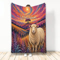 Sheep throw blanket featuring a colorful mountain sunset, wildflowers, and expressive farm animal artwork