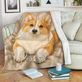Corgi blanket draped over a living room sofa with cozy neutral dog artwork