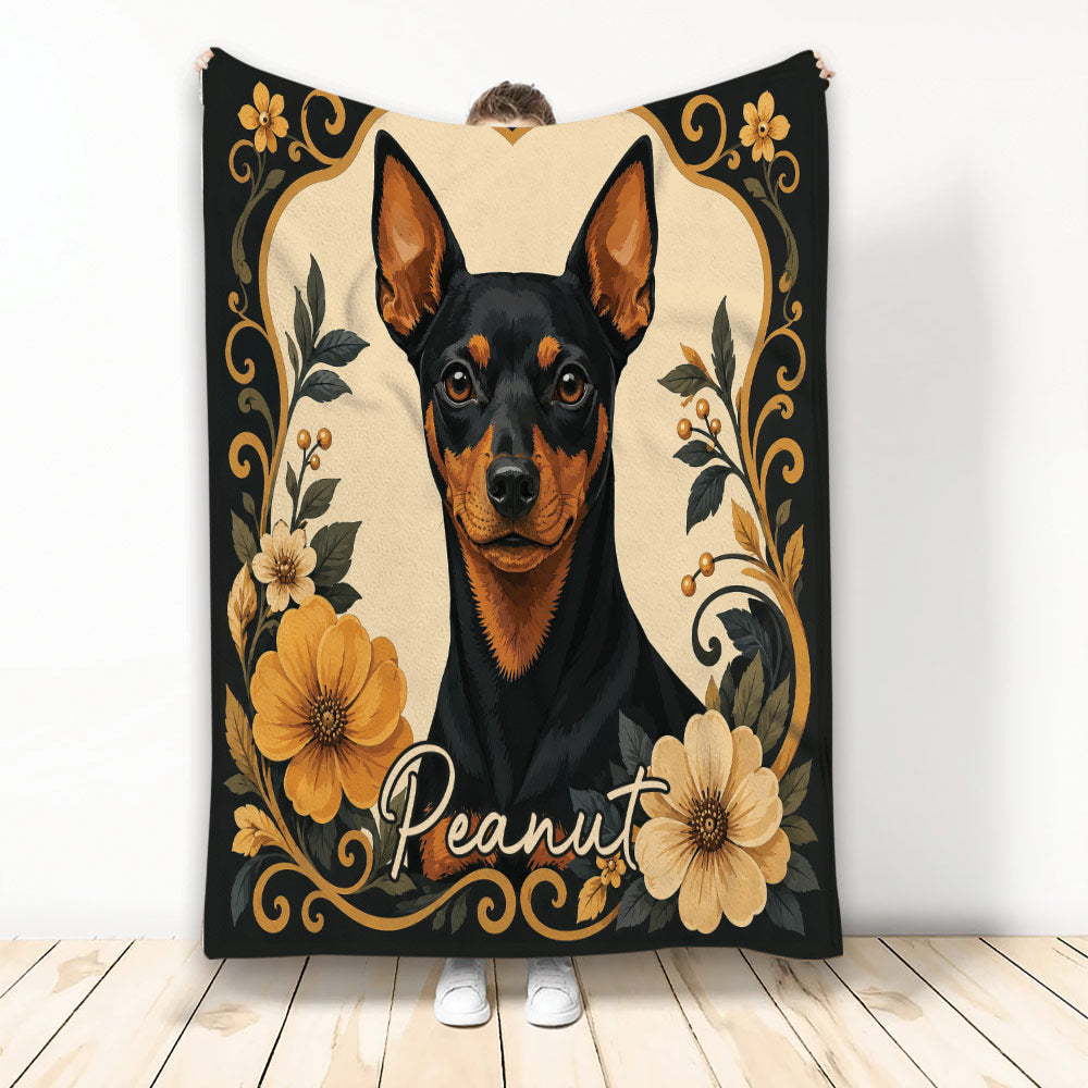 Miniature Pinscher blanket with black and tan dog artwork framed by gold floral accents