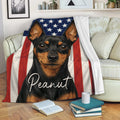 Patriotic Miniature Pinscher throw blanket displayed on a sofa with a bold dog design