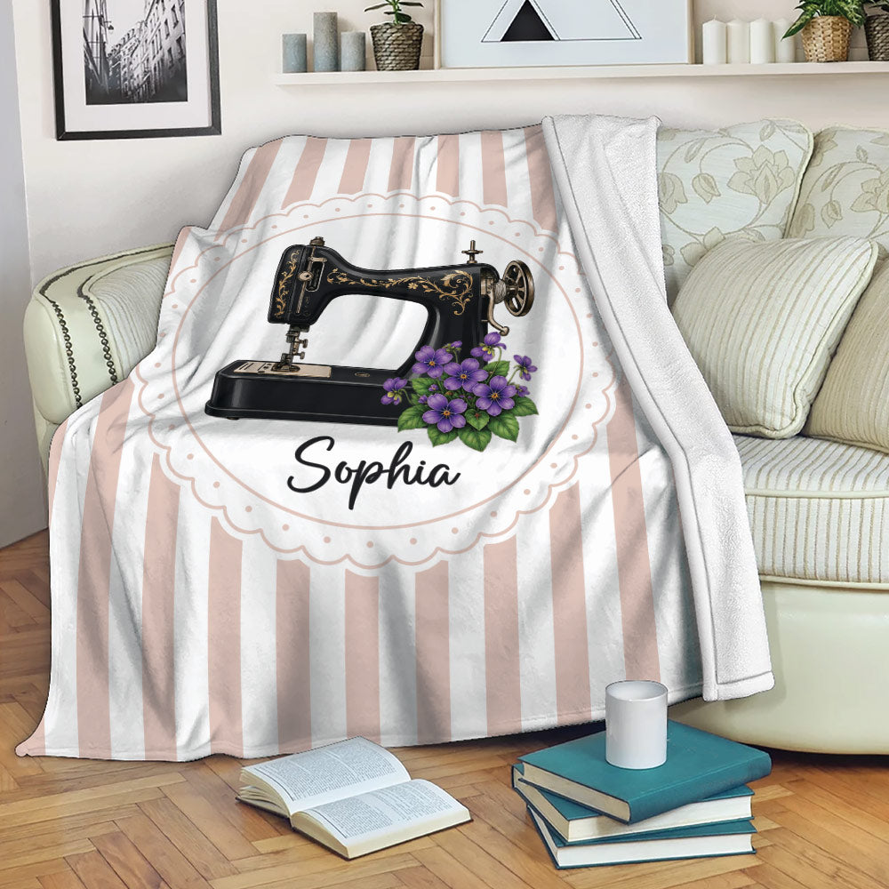 Sewing machine floral throw blanket draped over a sofa in a cozy reading space