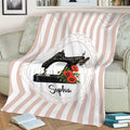 Floral sewing machine blanket displayed over a sofa with a soft pink and white striped background