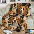 Close view of a beagle blanket spread across a sofa, featuring a repeating dog portrait design