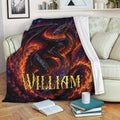 Dragon throw blanket draped over a sofa with fiery fantasy artwork in deep red, orange, and blue tones