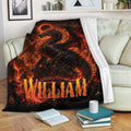 Dark dragon throw blanket draped over a sofa with glowing red fantasy artwork