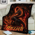 Dramatic red and black dragon blanket styled on a couch with fiery fantasy scenery