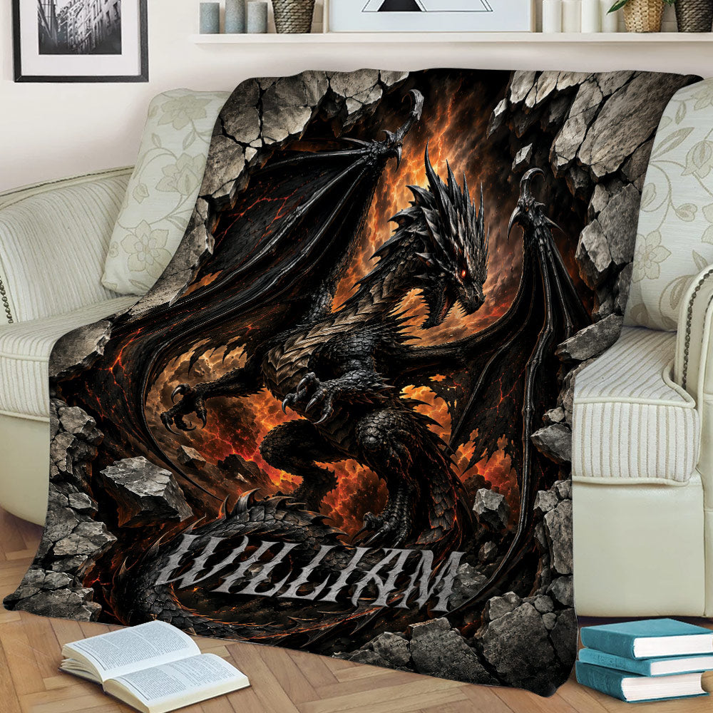 Black dragon throw blanket featuring wings, flames, and rocky fantasy artwork on a sofa