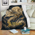 Dragon throw blanket draped across a sofa with moonlit fantasy artwork and cosmic gold accents