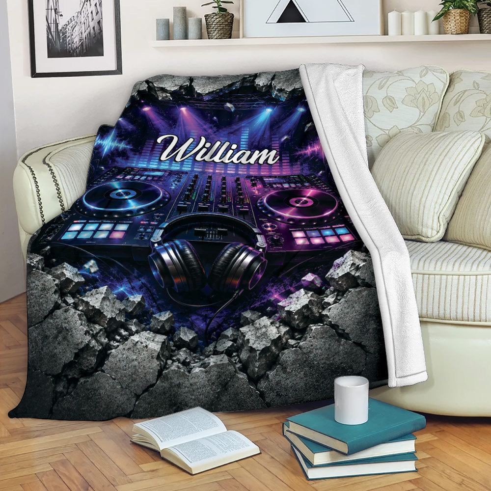 DJ throw blanket displayed on a sofa with turntables, headphones, speakers, and concert lighting artwork