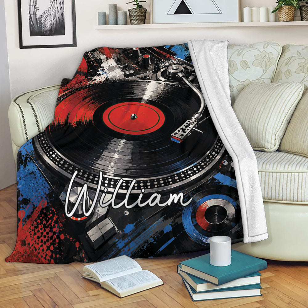 DJ blanket draped over a sofa with turntable and vinyl record artwork in a music-inspired living room