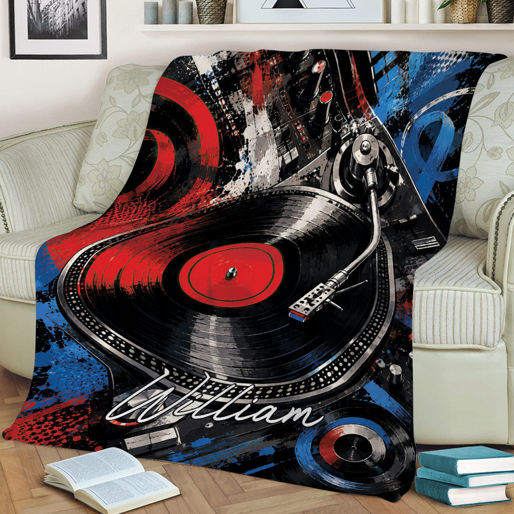 Colorful DJ throw blanket displayed on a sofa with turntable, vinyl record, and bold abstract artwork
