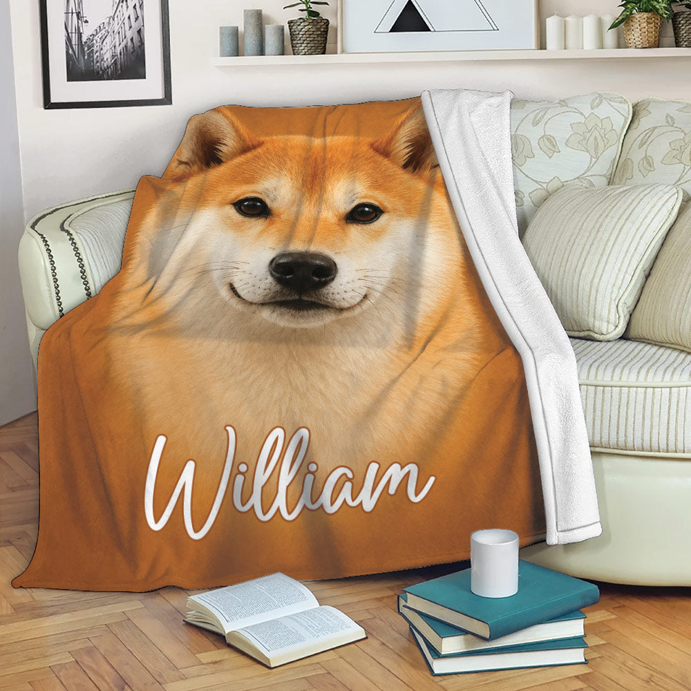 Shiba Inu throw blanket draped over a sofa in a cozy living room