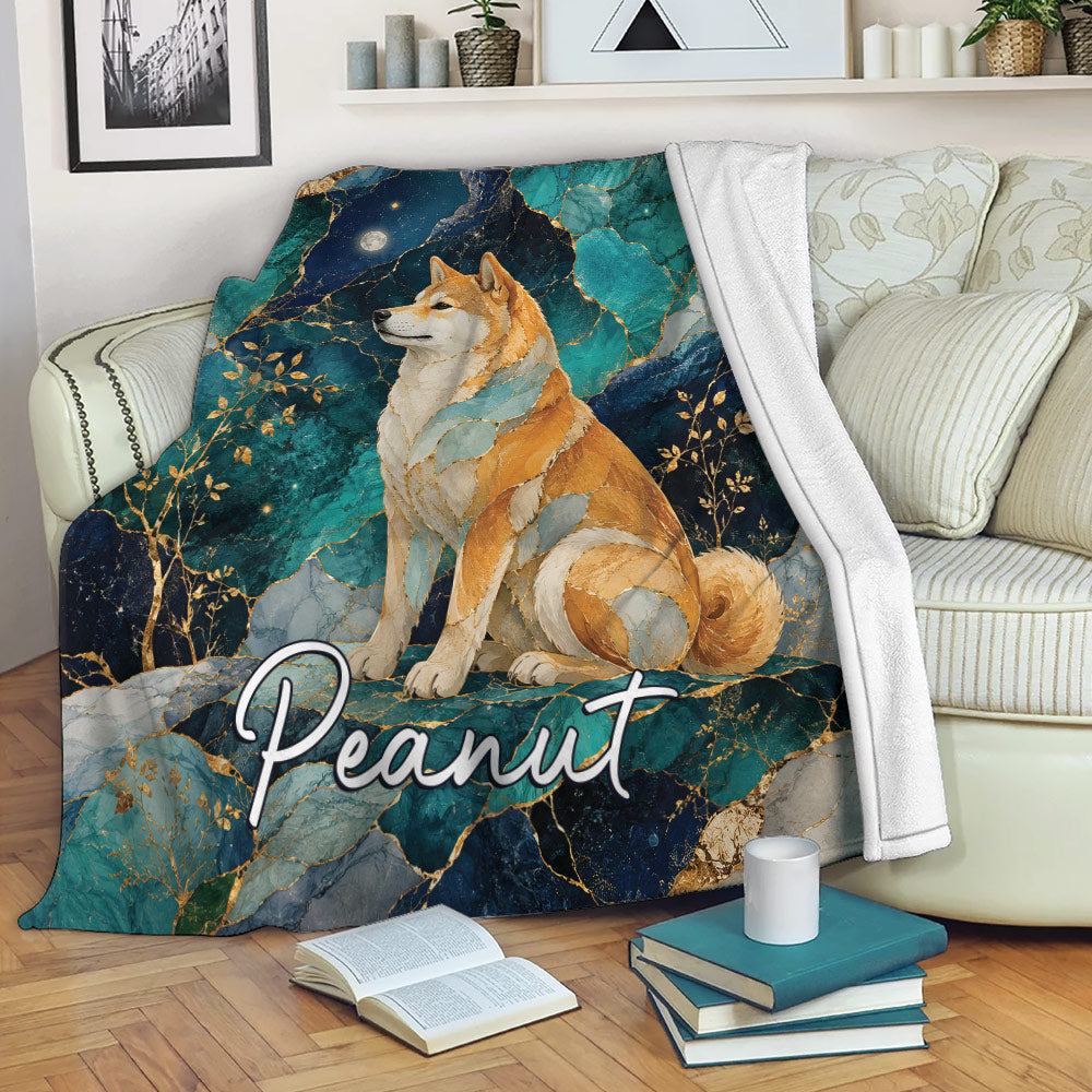 Shiba Inu blanket draped over a sofa, showcasing teal and navy marble artwork with gold botanical accents