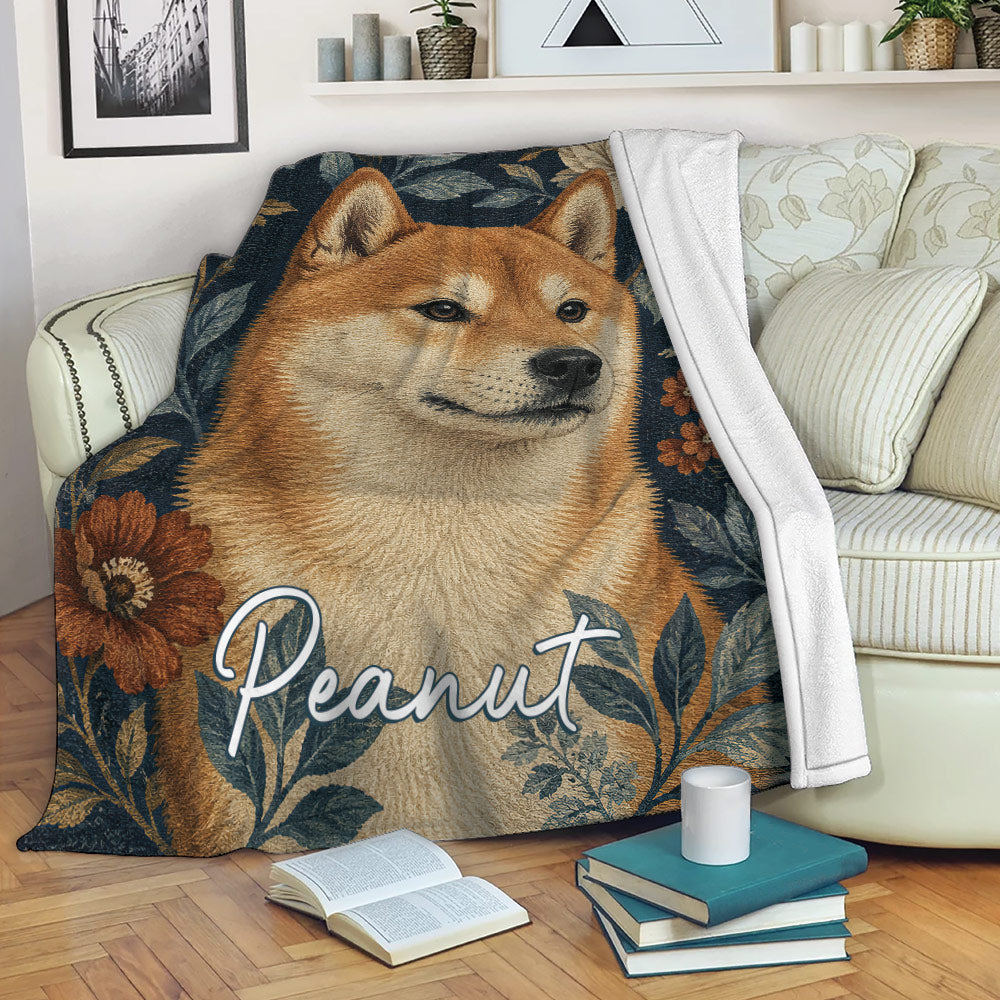 Shiba Inu blanket draped over a sofa with botanical artwork in a cozy living room