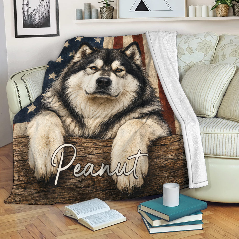 Alaskan Malamute throw blanket displayed on a sofa with patriotic flag artwork
