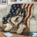 Alaskan Malamute blanket draped over a couch with stars, stripes, and rustic artwork