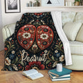 Floral ladybug throw blanket draped over a sofa in a cozy living room setting