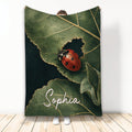 Ladybug throw blanket featuring a red spotted insect on green leaves in a dark nature-inspired design