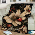 Ladybug blanket draped over a sofa, featuring large flowers, red spotted ladybugs, and dark botanical detail