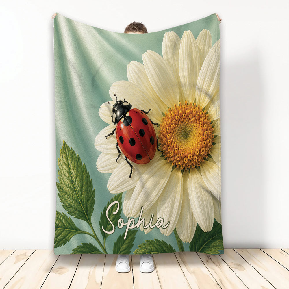 Ladybug throw blanket featuring a red spotted beetle on a large white flower with green leaves
