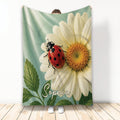 Ladybug throw blanket featuring a red spotted beetle on a large white flower with green leaves