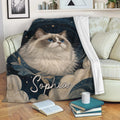 Ragdoll cat blanket draped over a sofa, featuring blue-eyed cat artwork and a starry navy design