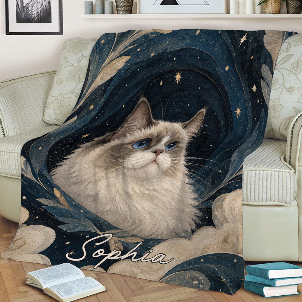 Ragdoll cat throw blanket displayed on a couch with celestial artwork, swirling leaves, and star details