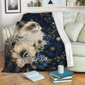 Ragdoll cat blanket draped over a sofa with navy and beige floral artwork