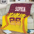 Softball couch blanket featuring vivid yellow artwork, red stitching, and colorful sports-themed details