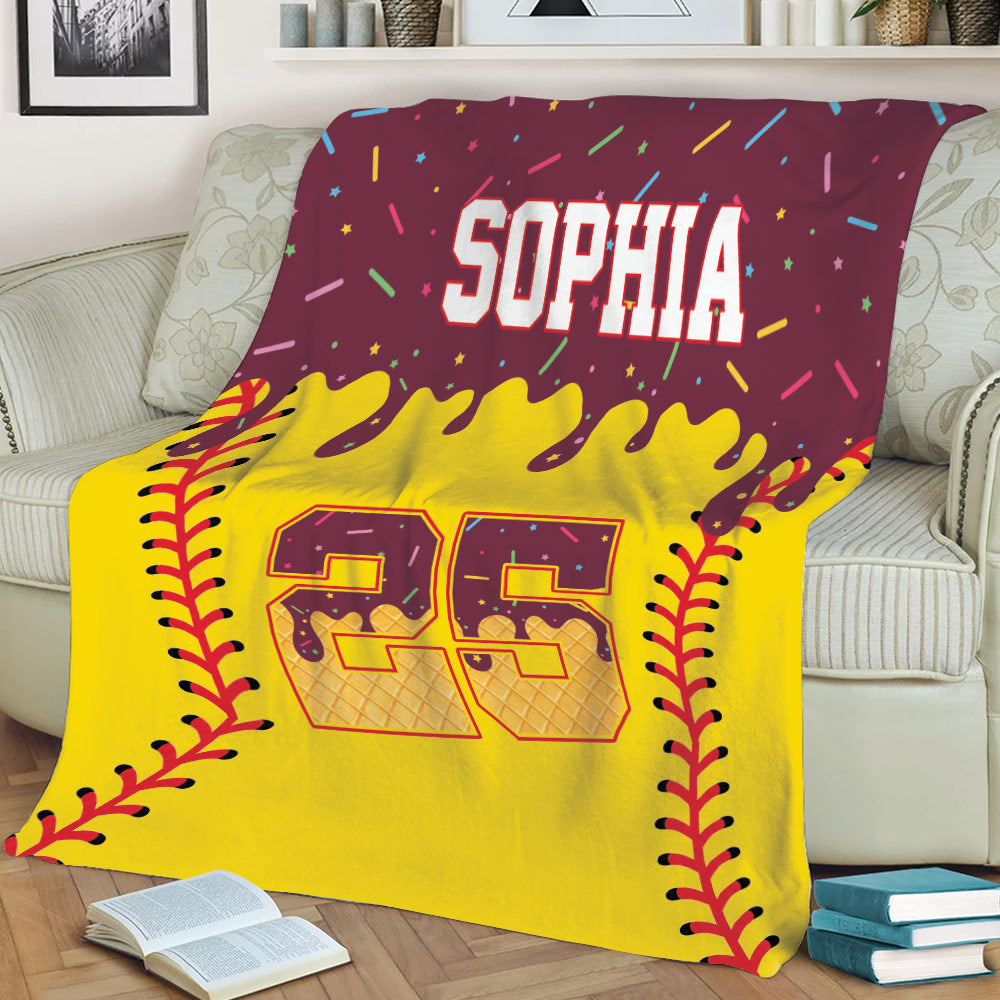 Softball couch blanket featuring vivid yellow artwork, red stitching, and colorful sports-themed details