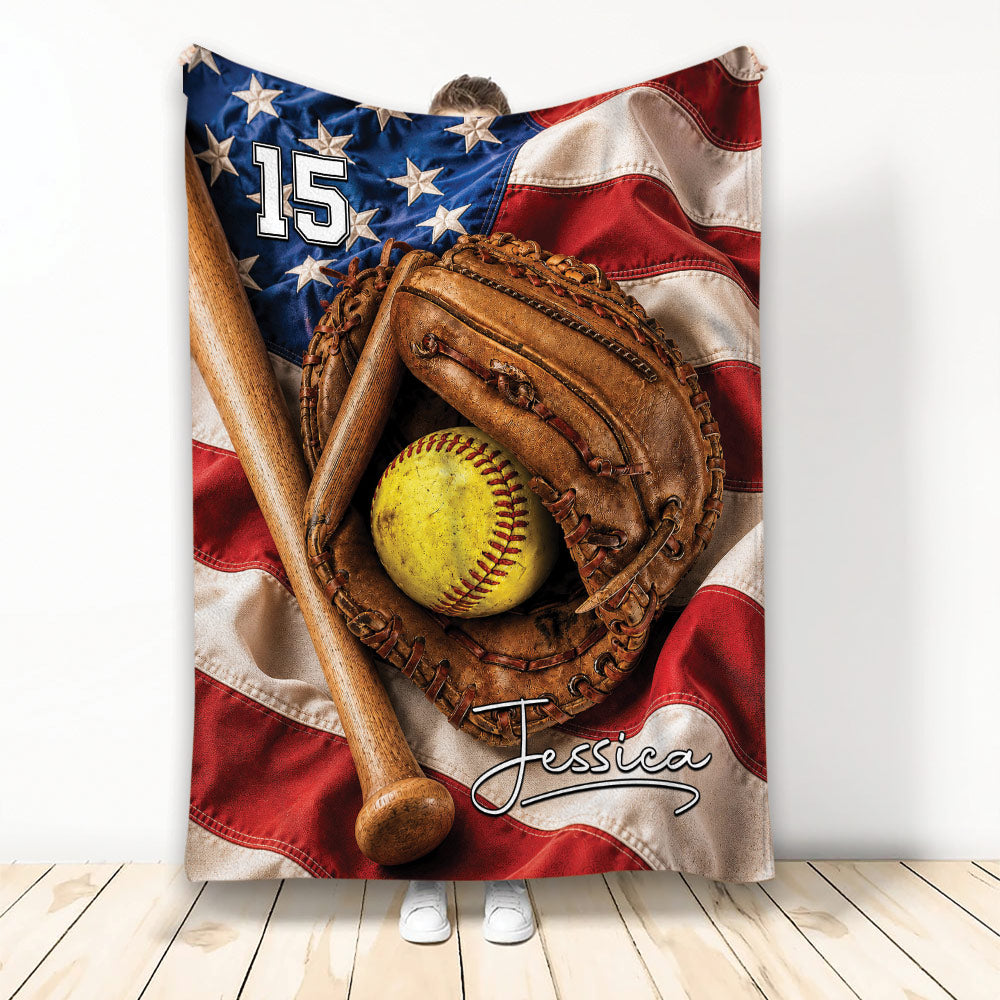 Softball throw blanket with a glove, bat, yellow softball, stars, and patriotic American flag design