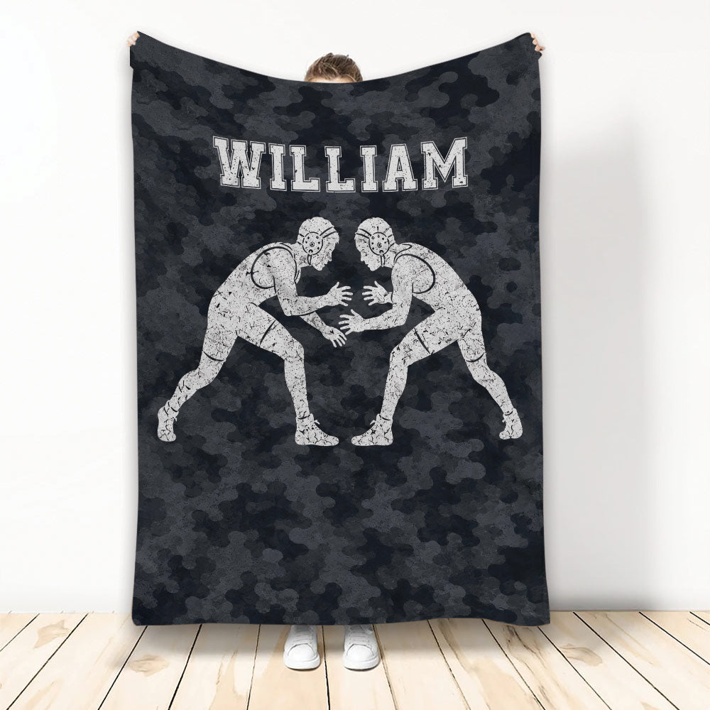 Wrestling throw blanket with two grapplers in headgear on a dark camouflage background
