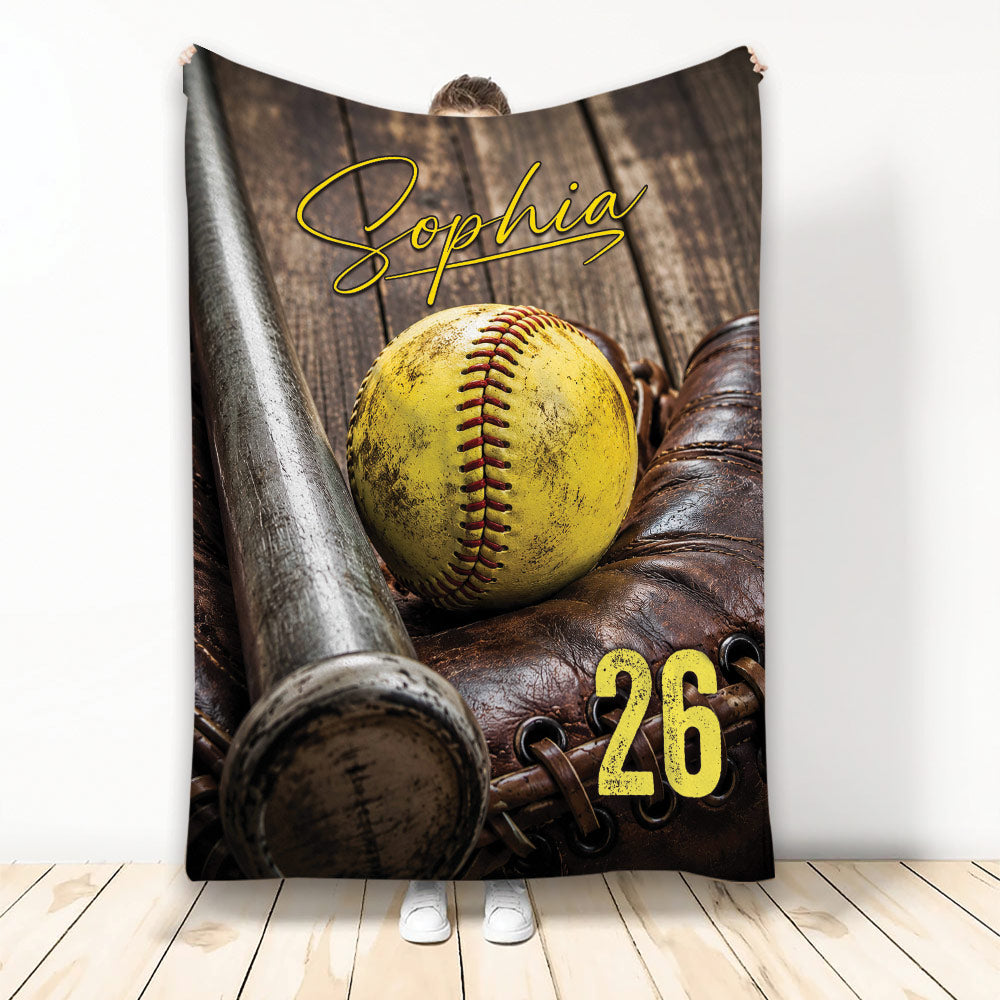 Softball blanket featuring a yellow softball, bat, leather glove, and rustic wood sports background