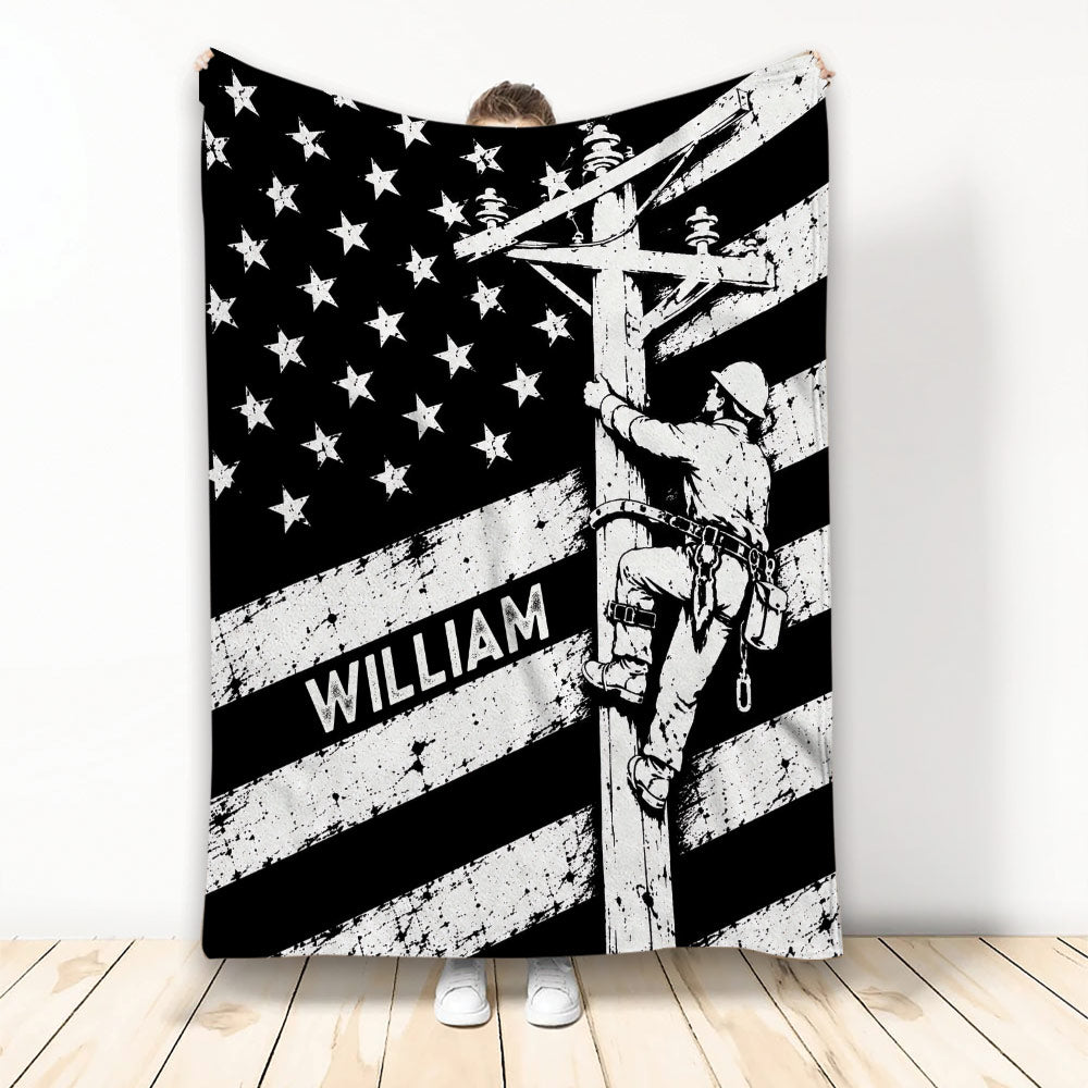 Black and white lineman blanket featuring a utility worker climbing a power pole beneath stars and stripes